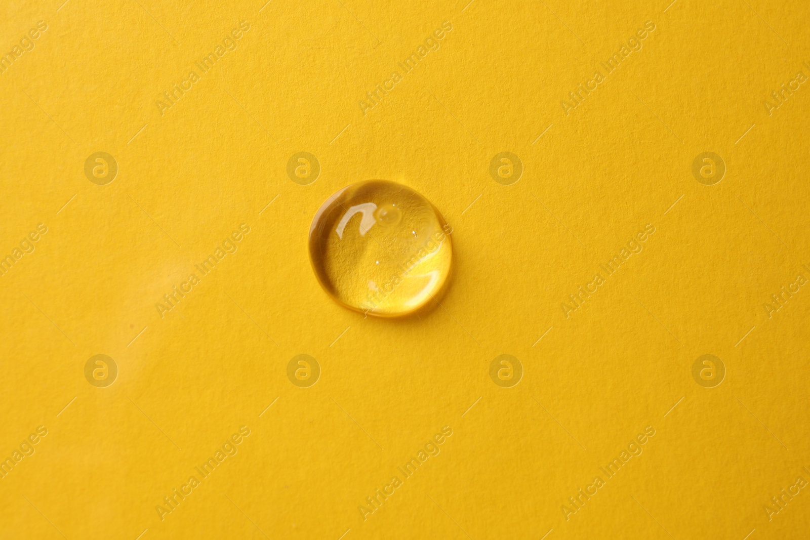 Photo of Sample of cosmetic product on yellow background, top view