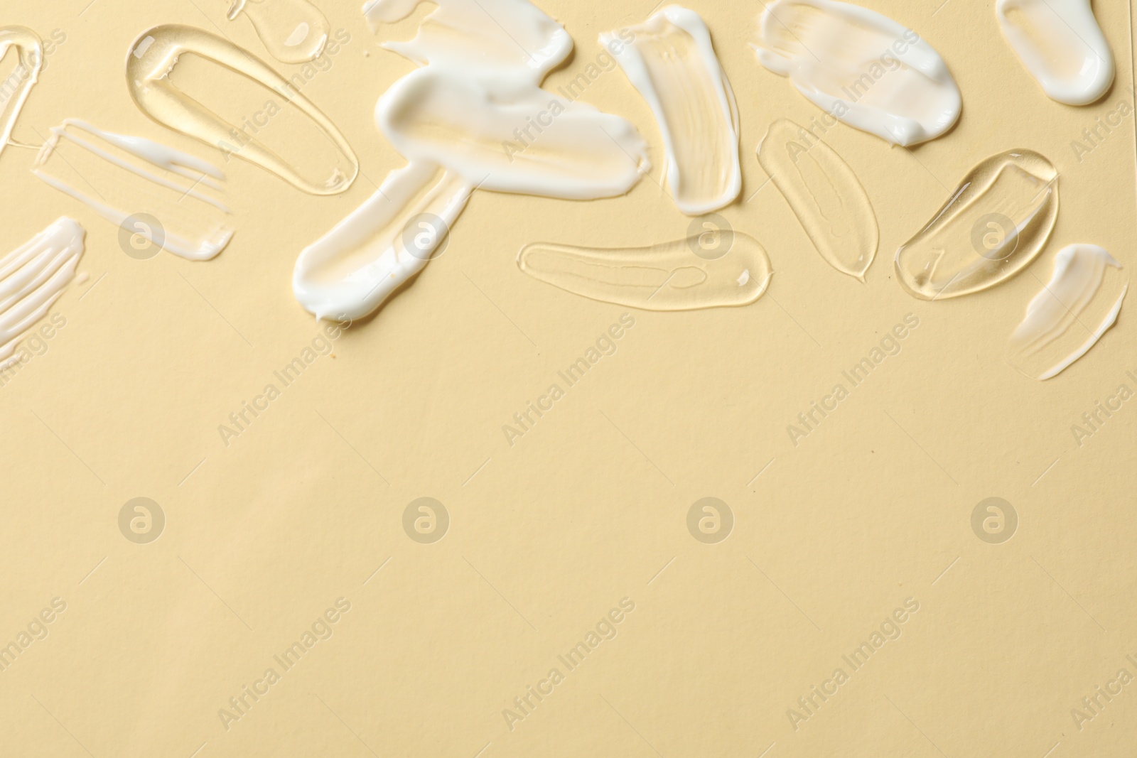 Photo of Samples of different cosmetic products on beige background, flat lay. Space for text