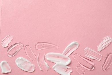 Photo of Samples of different cosmetic products on pink background, flat lay. Space for text