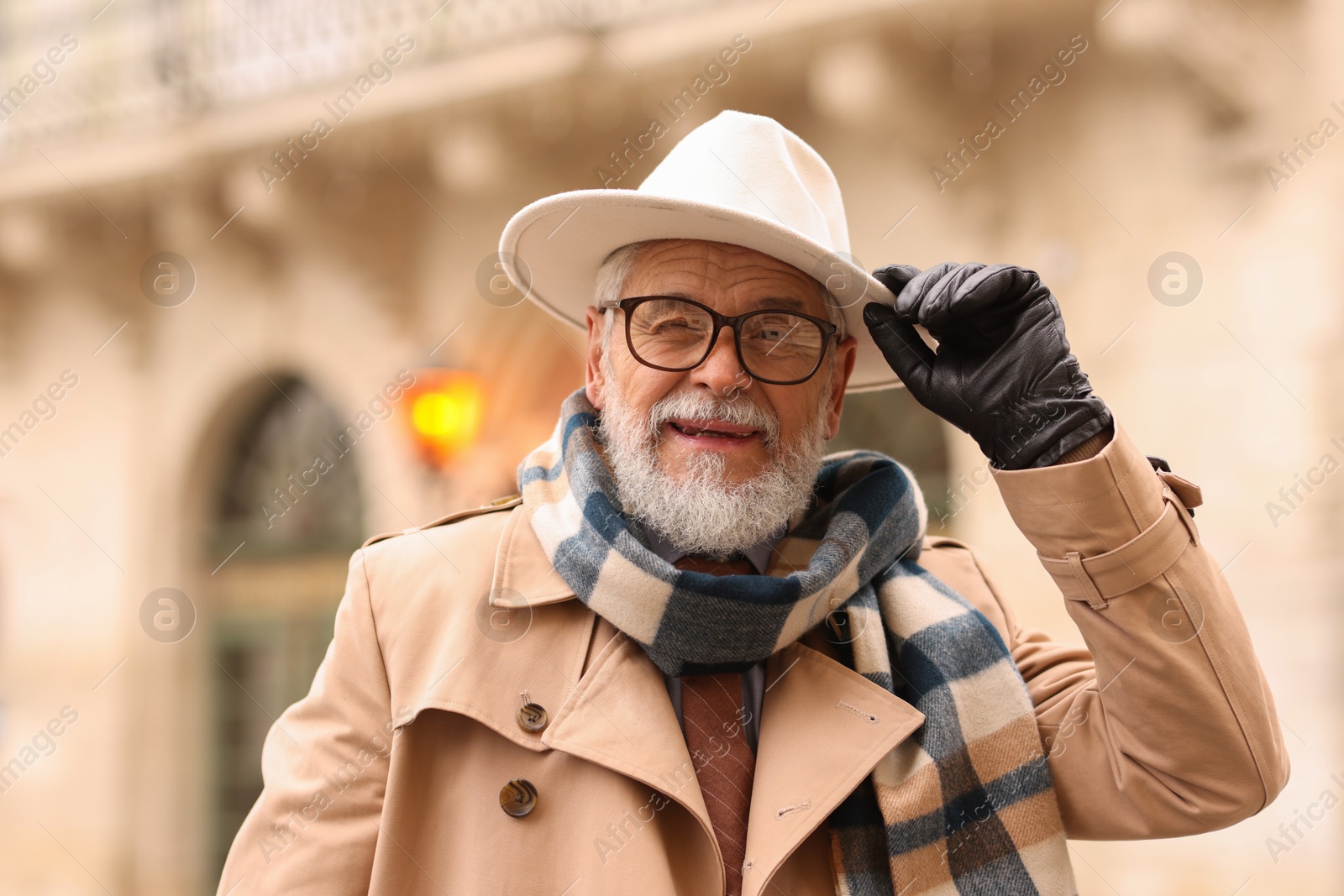 Photo of Stylish bearded senior man on city street