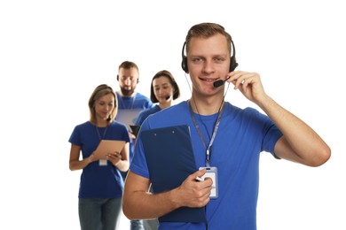 Photo of Technical support call center. Team of friendly operators on white background