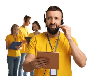 Photo of Technical support call center. Team of friendly operators on white background