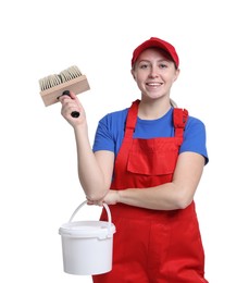 Professional painter with brush and bucket of paint on white background