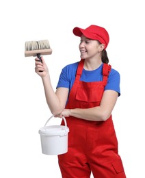 Professional painter with brush and bucket of paint on white background