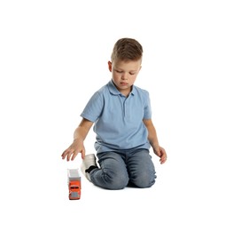 Photo of Little boy playing with toy car on white background