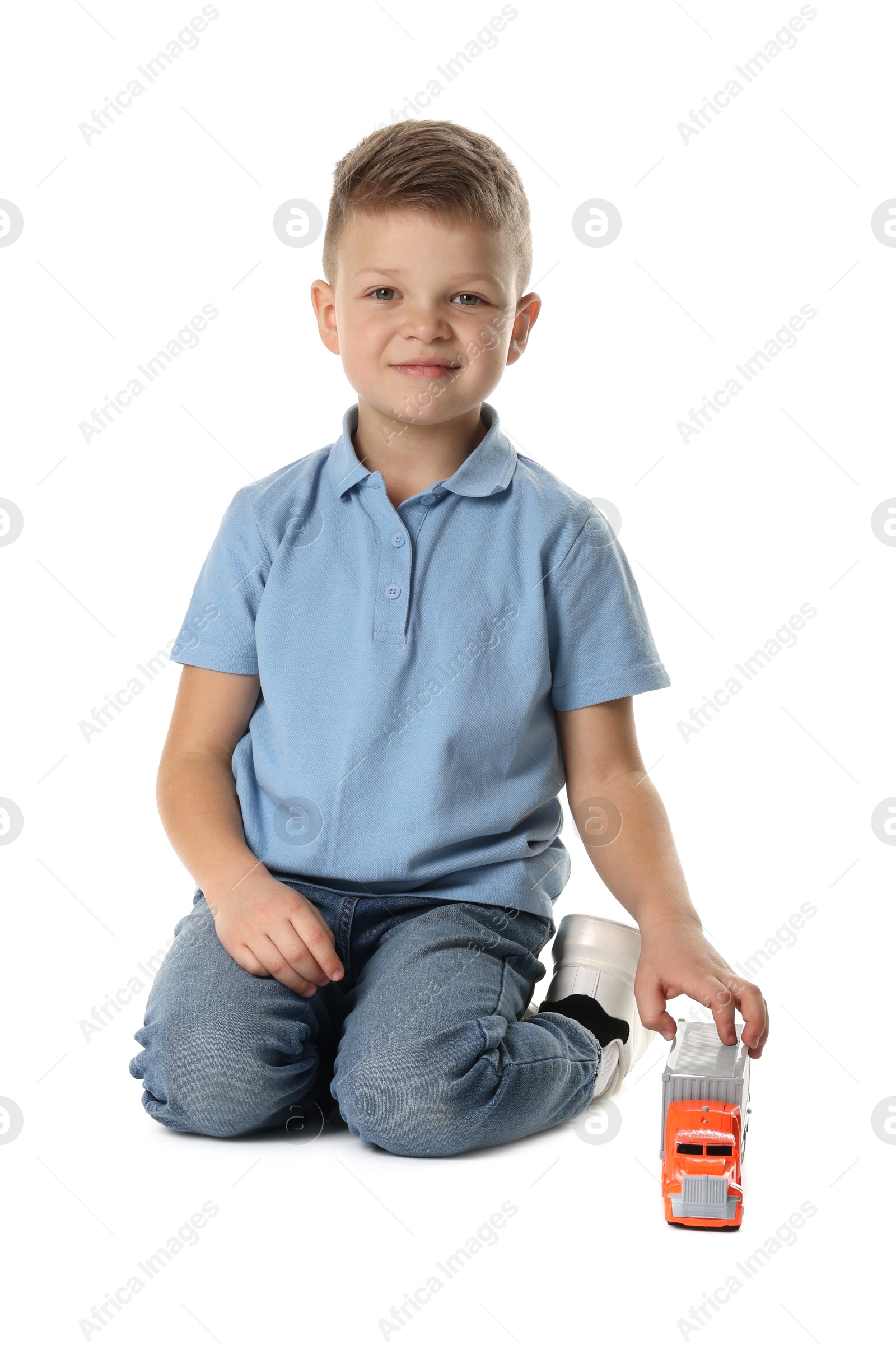 Photo of Little boy playing with toy car on white background