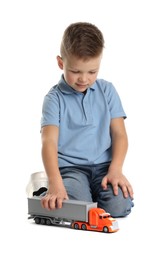 Photo of Little boy playing with toy car on white background