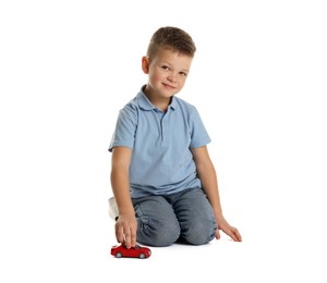 Photo of Little boy playing with toy car on white background