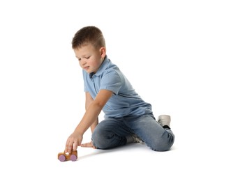 Little boy playing with toy car on white background