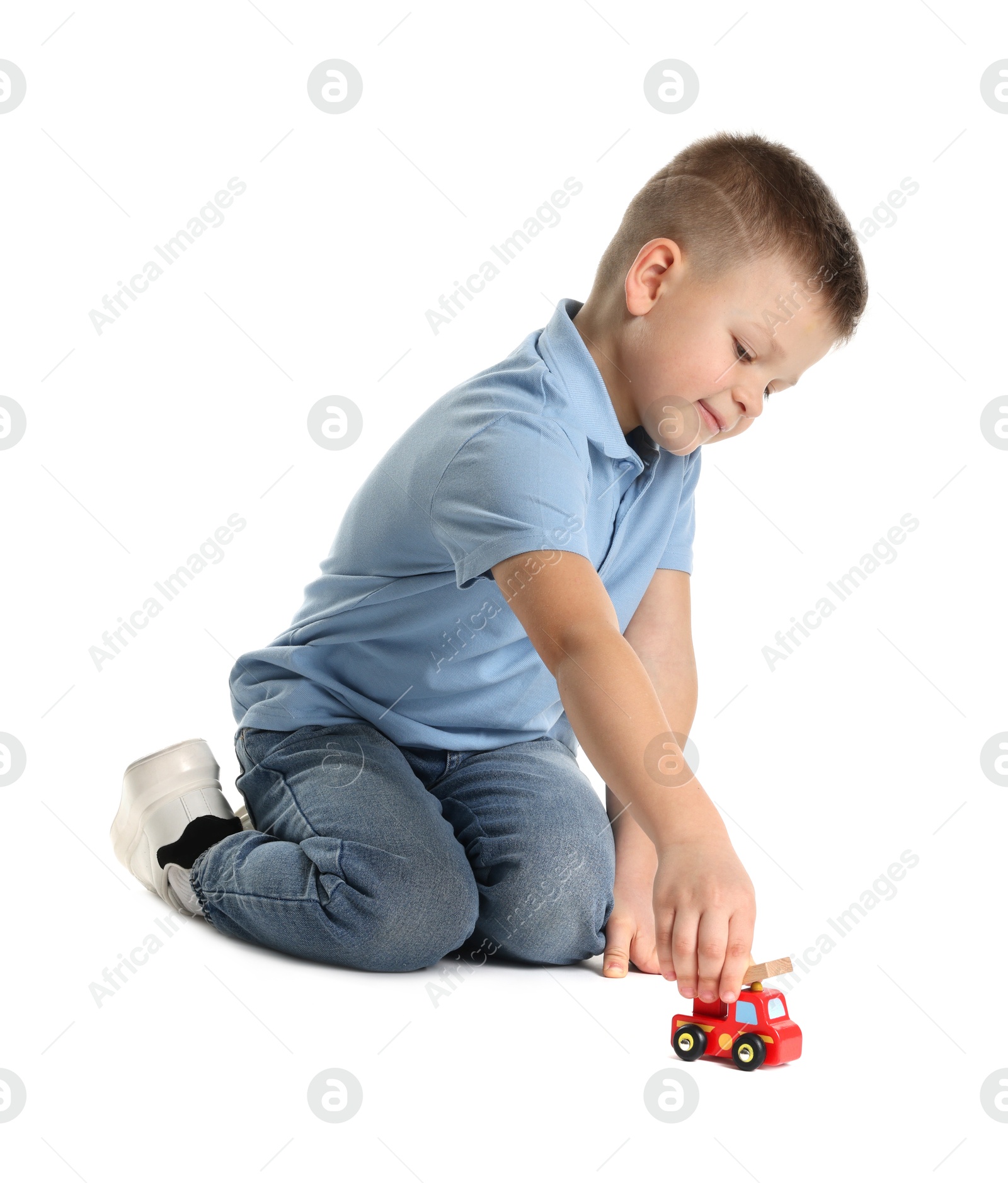 Photo of Little boy playing with toy car on white background