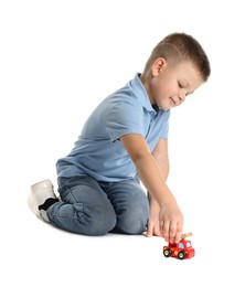 Photo of Little boy playing with toy car on white background