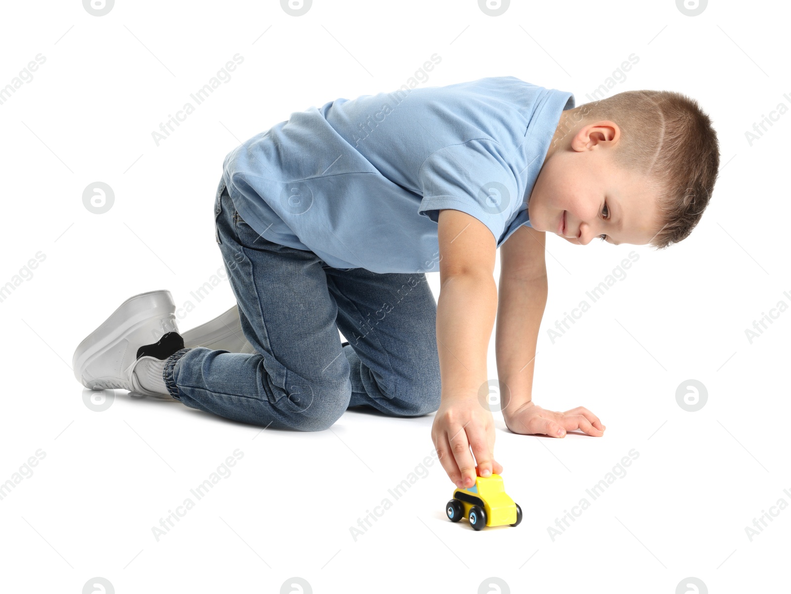 Photo of Little boy playing with toy car on white background