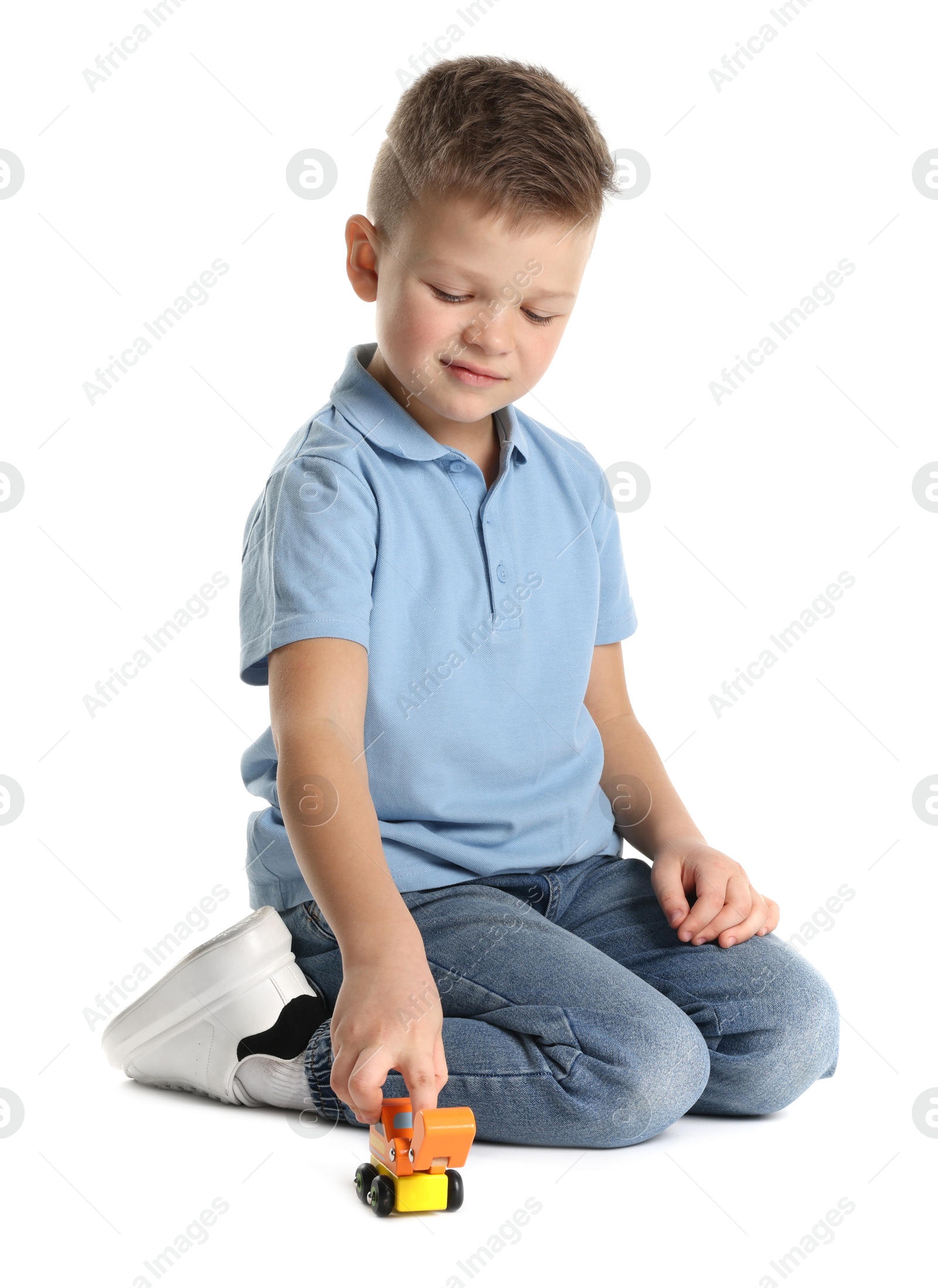 Photo of Little boy playing with toy car on white background