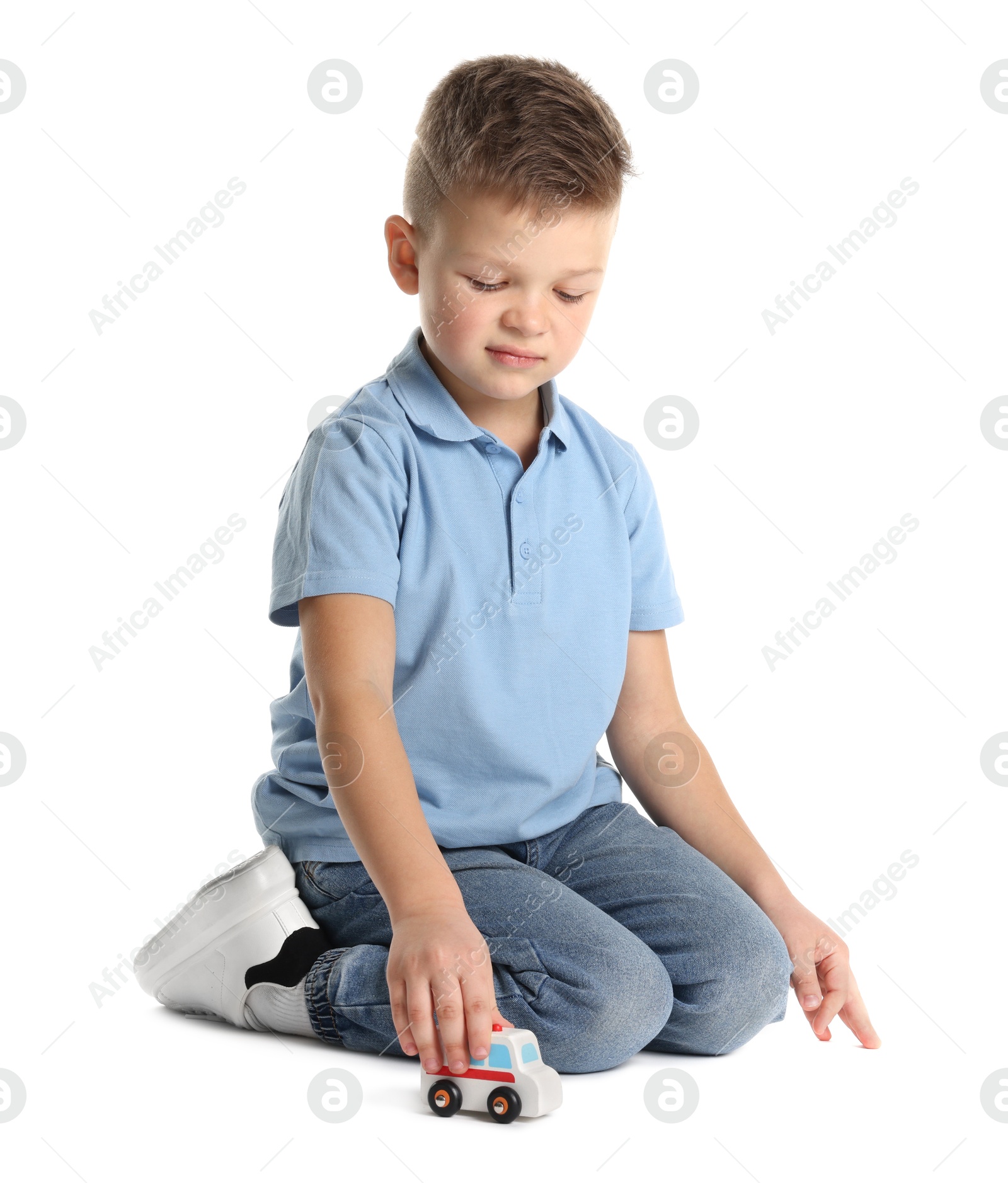 Photo of Little boy playing with toy car on white background