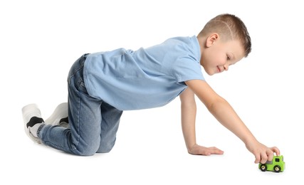 Photo of Little boy playing with toy car on white background