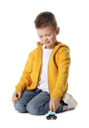 Photo of Little boy playing with toy car on white background