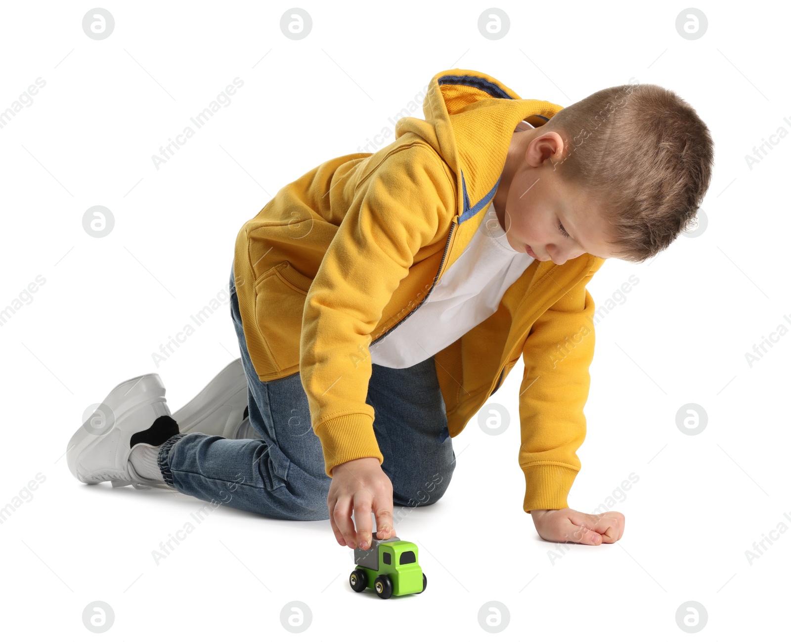 Photo of Little boy playing with toy car on white background