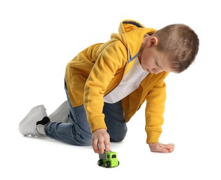 Photo of Little boy playing with toy car on white background