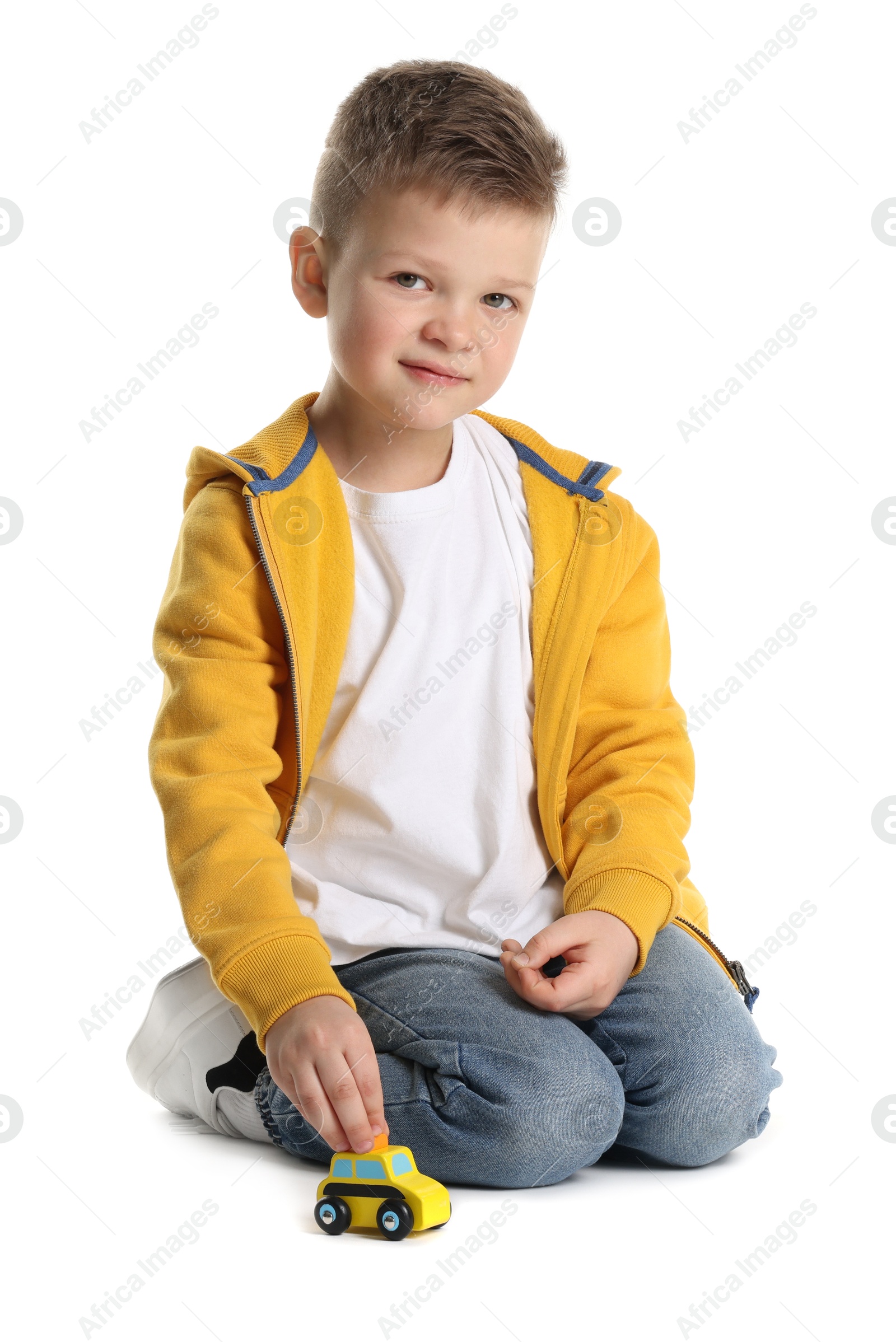 Photo of Little boy playing with toy car on white background