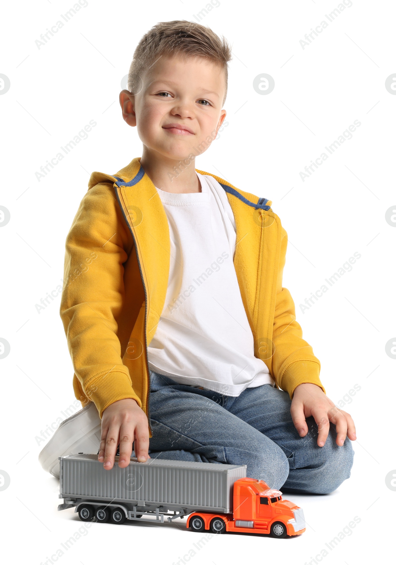 Photo of Little boy playing with toy car on white background