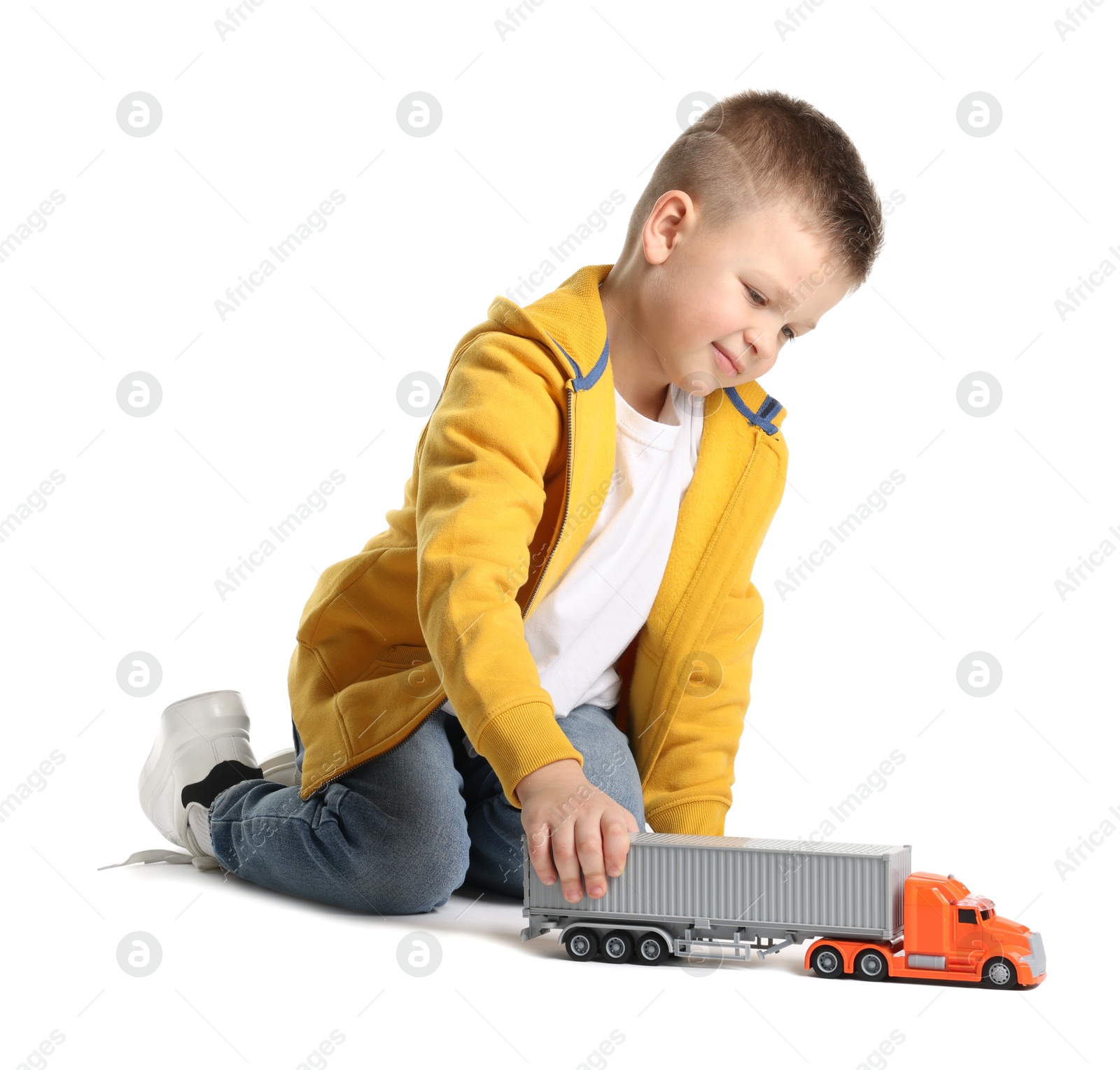 Photo of Little boy playing with toy car on white background