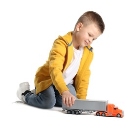 Photo of Little boy playing with toy car on white background