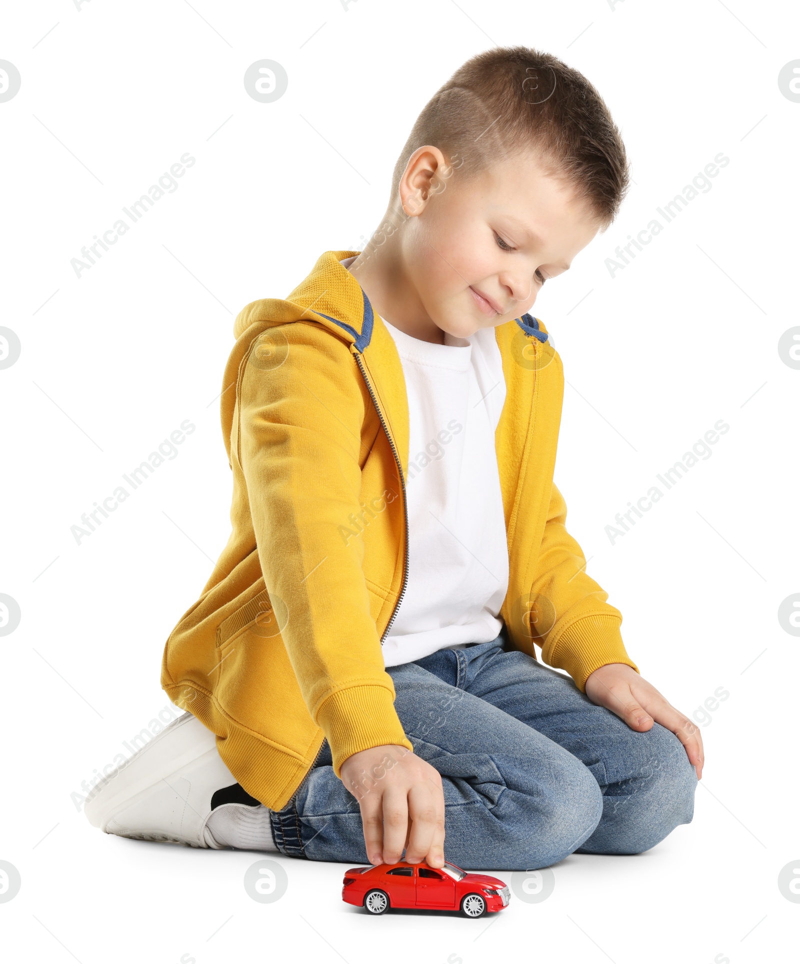 Photo of Little boy playing with toy car on white background