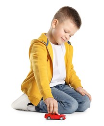 Photo of Little boy playing with toy car on white background