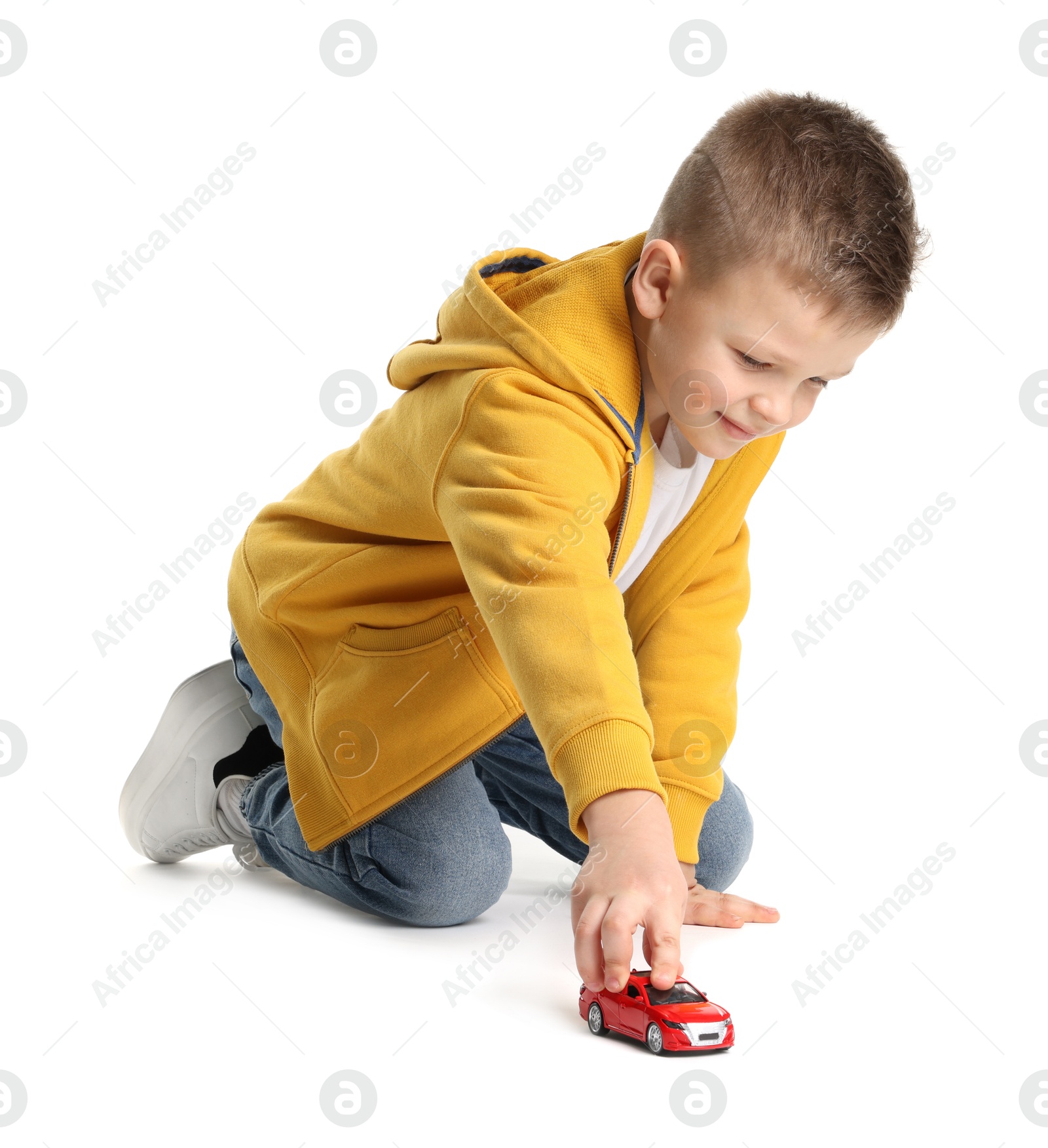 Photo of Little boy playing with toy car on white background