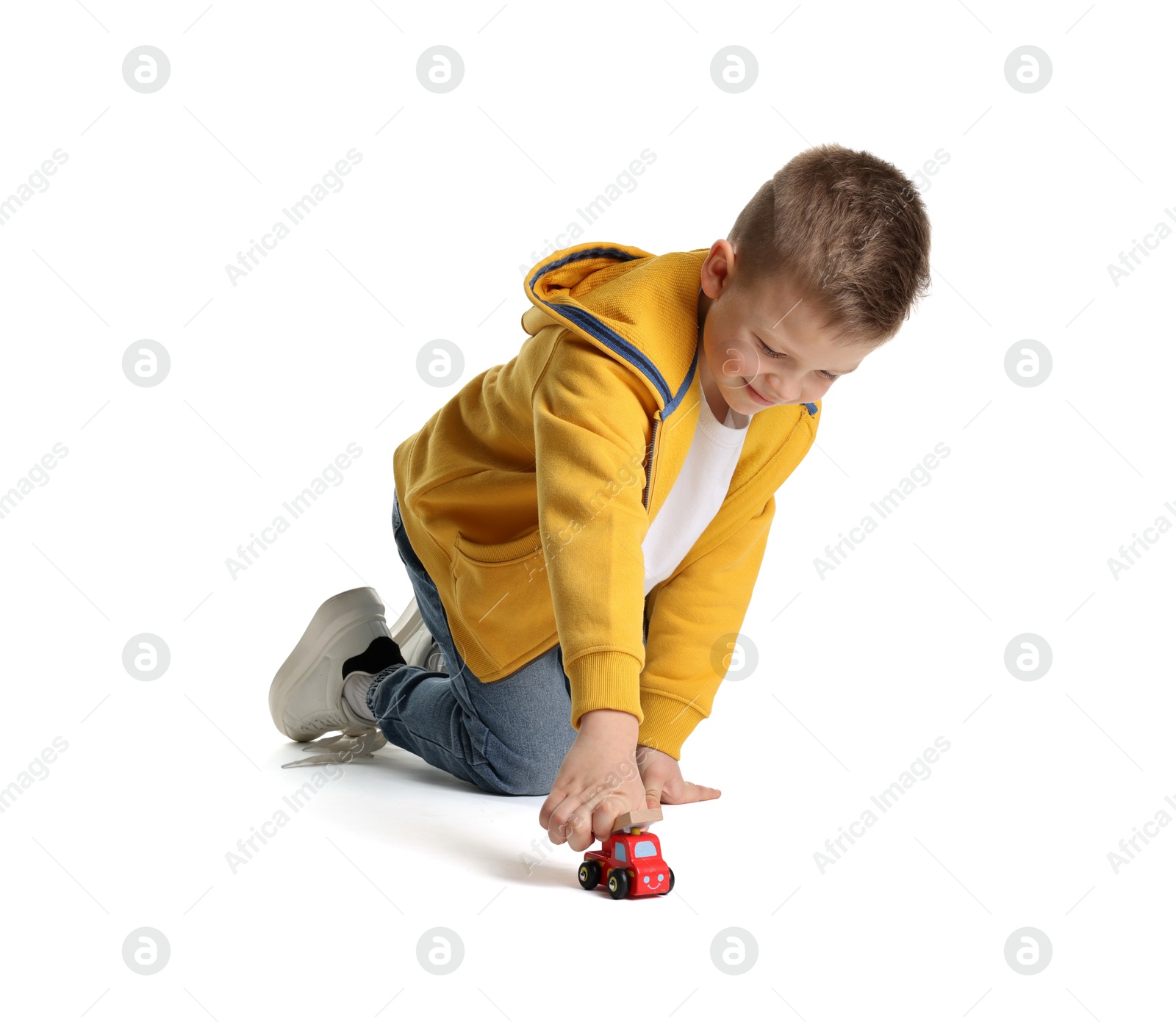 Photo of Little boy playing with toy car on white background