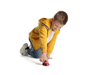 Little boy playing with toy car on white background