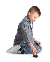 Photo of Little boy playing with toy car on white background