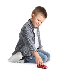 Photo of Little boy playing with toy car on white background