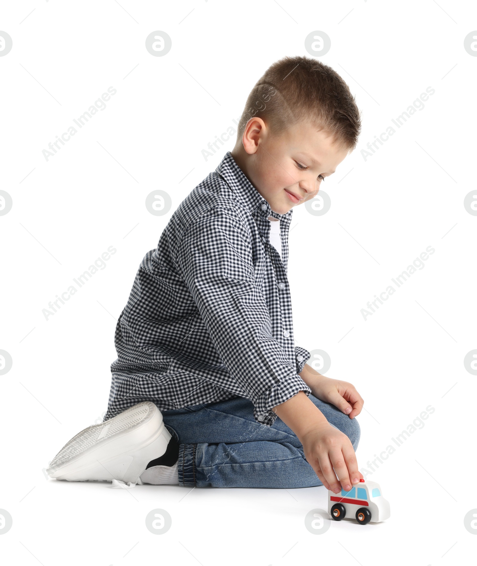 Photo of Little boy playing with toy car on white background