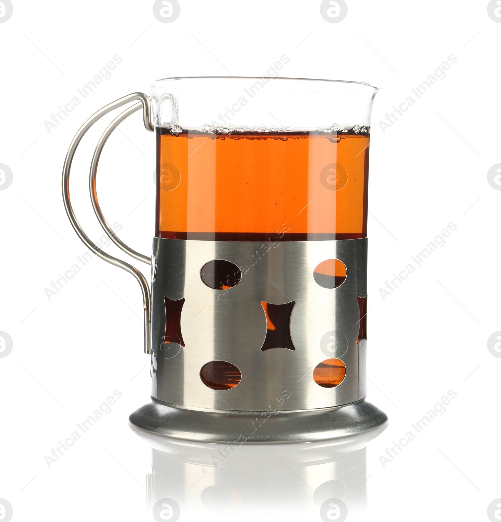 Photo of Glass of aromatic tea in holder isolated on white