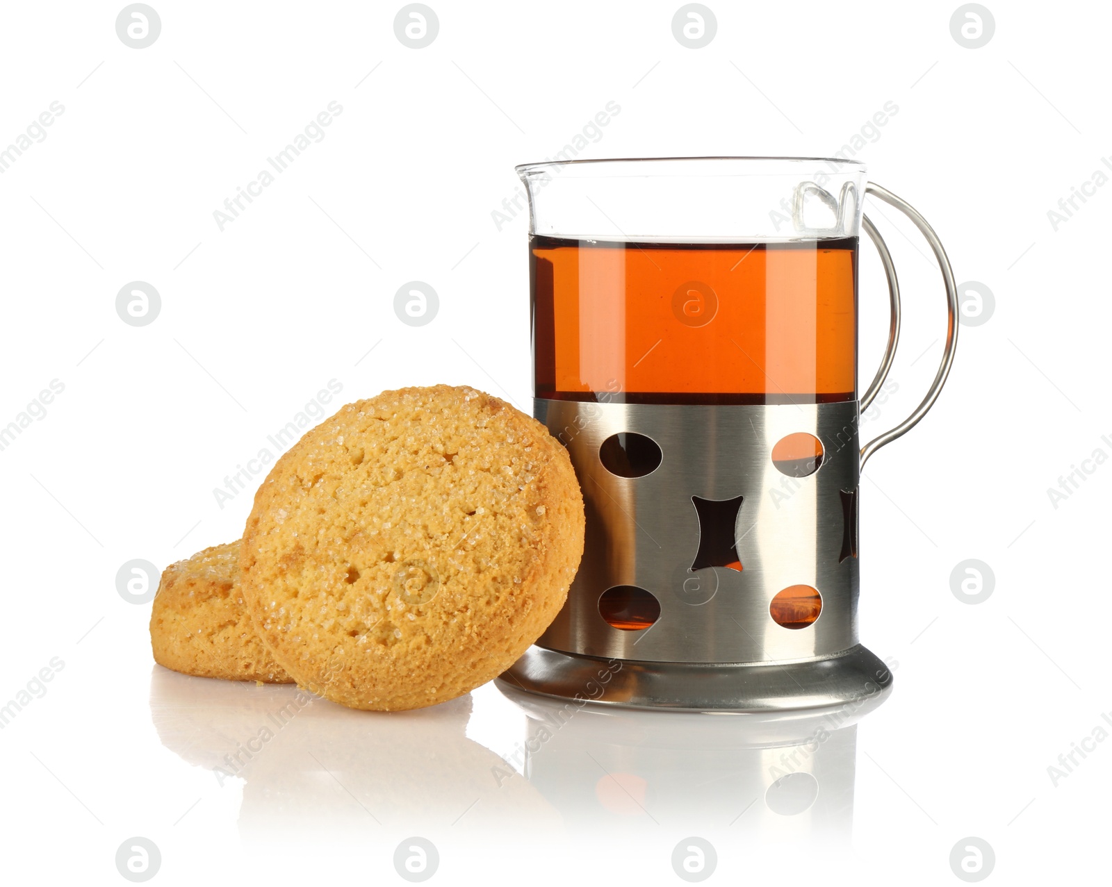 Photo of Glass of aromatic tea in holder and cookies isolated on white