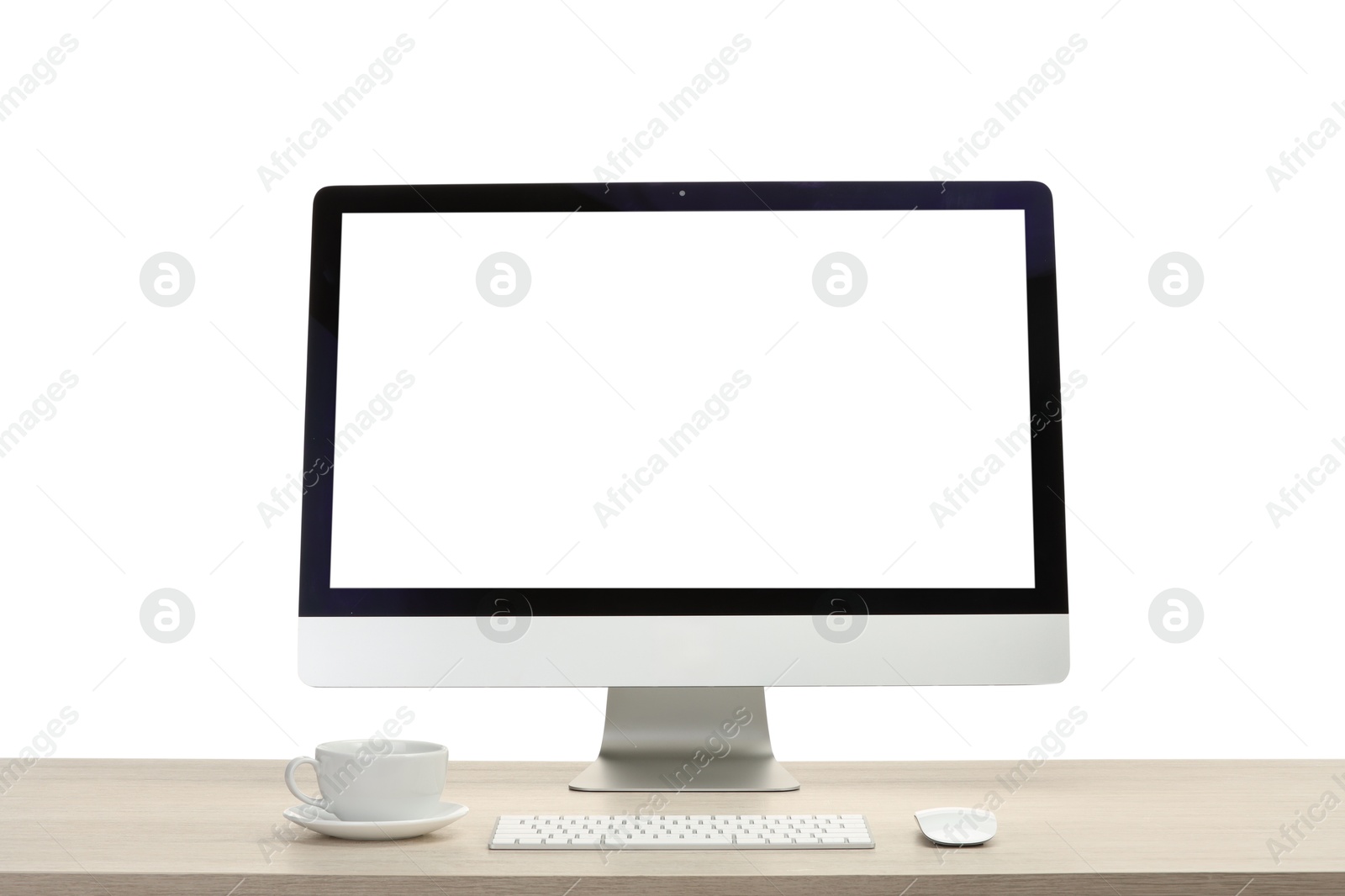 Photo of Computer monitor, keyboard, mouse and cup of drink on wooden desk against white background