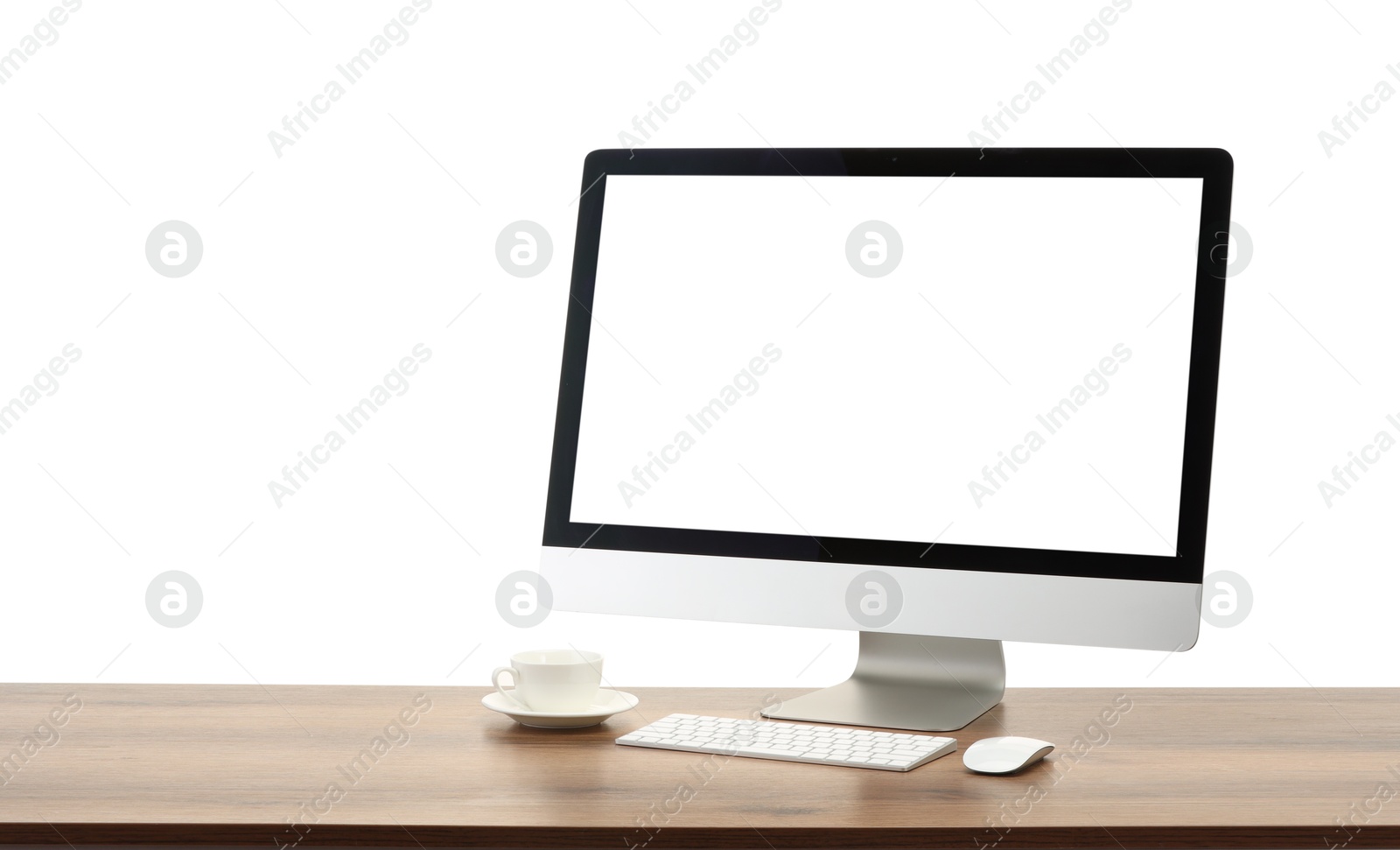 Photo of Computer monitor, keyboard, mouse and cup of drink on wooden desk against white background