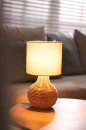 Photo of Stylish night lamp on wooden table indoors