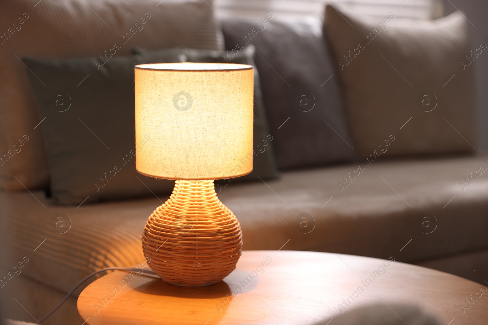 Photo of Stylish night lamp on wooden table in room, space for text