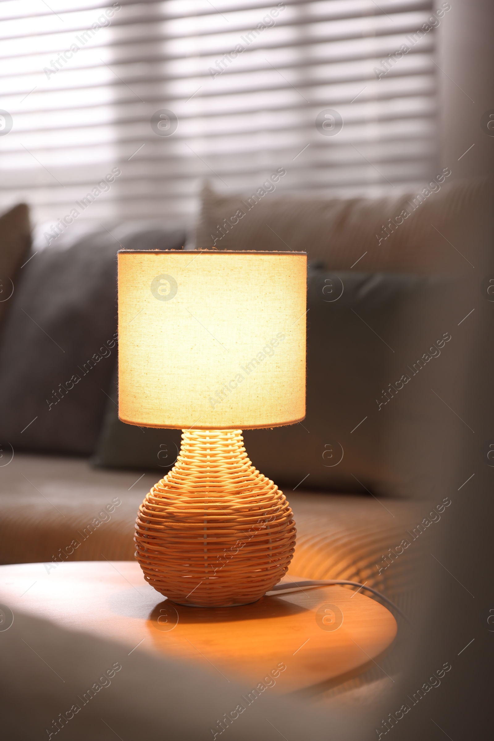 Stylish night lamp on wooden table indoors Photo of Stylish night lamp on wooden table indoors
