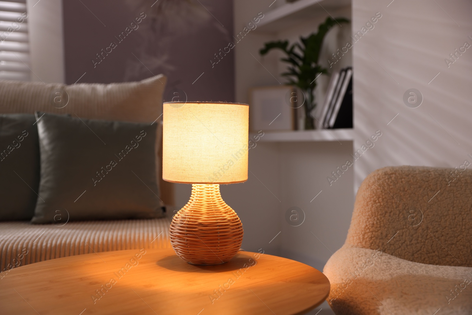 Photo of Stylish night lamp on wooden table in room. Interior design