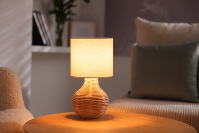 Photo of Stylish night lamp on wooden table indoors