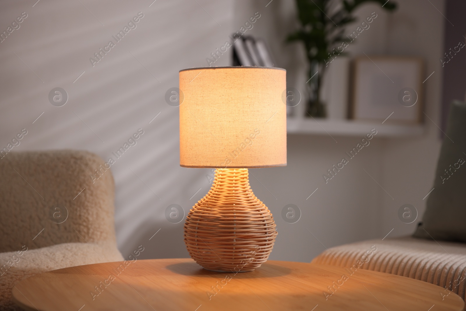 Photo of Stylish night lamp on wooden table indoors