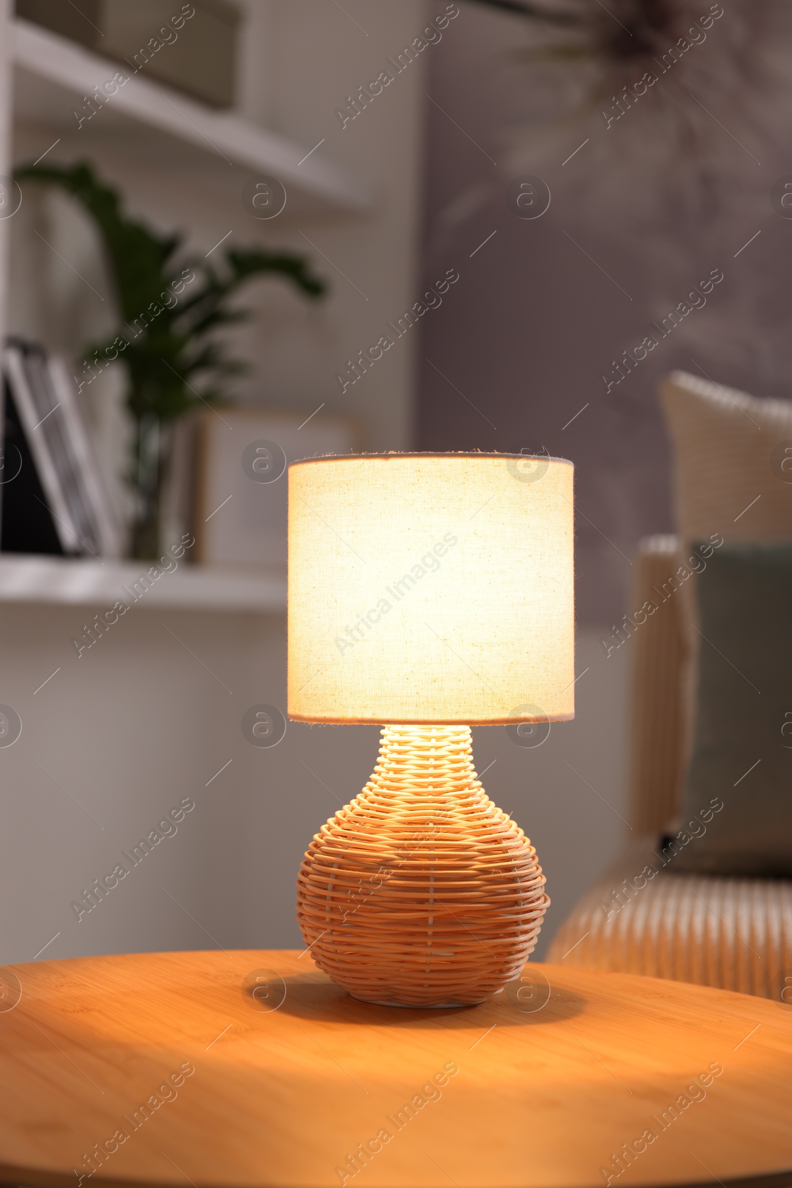 Stylish night lamp on wooden table indoors Photo of Stylish night lamp on wooden table indoors