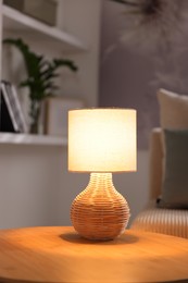 Photo of Stylish night lamp on wooden table indoors