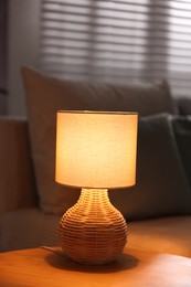 Photo of Stylish night lamp on wooden table indoors