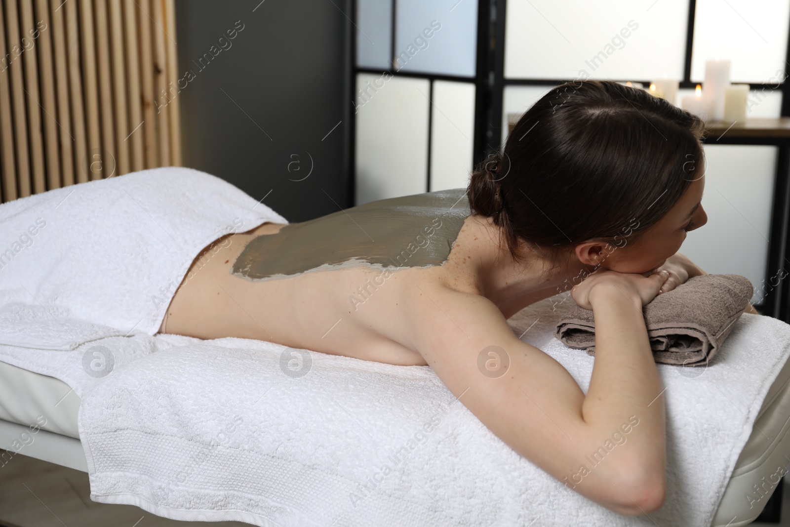 Photo of Woman undergoing body wraps treatment in spa salon