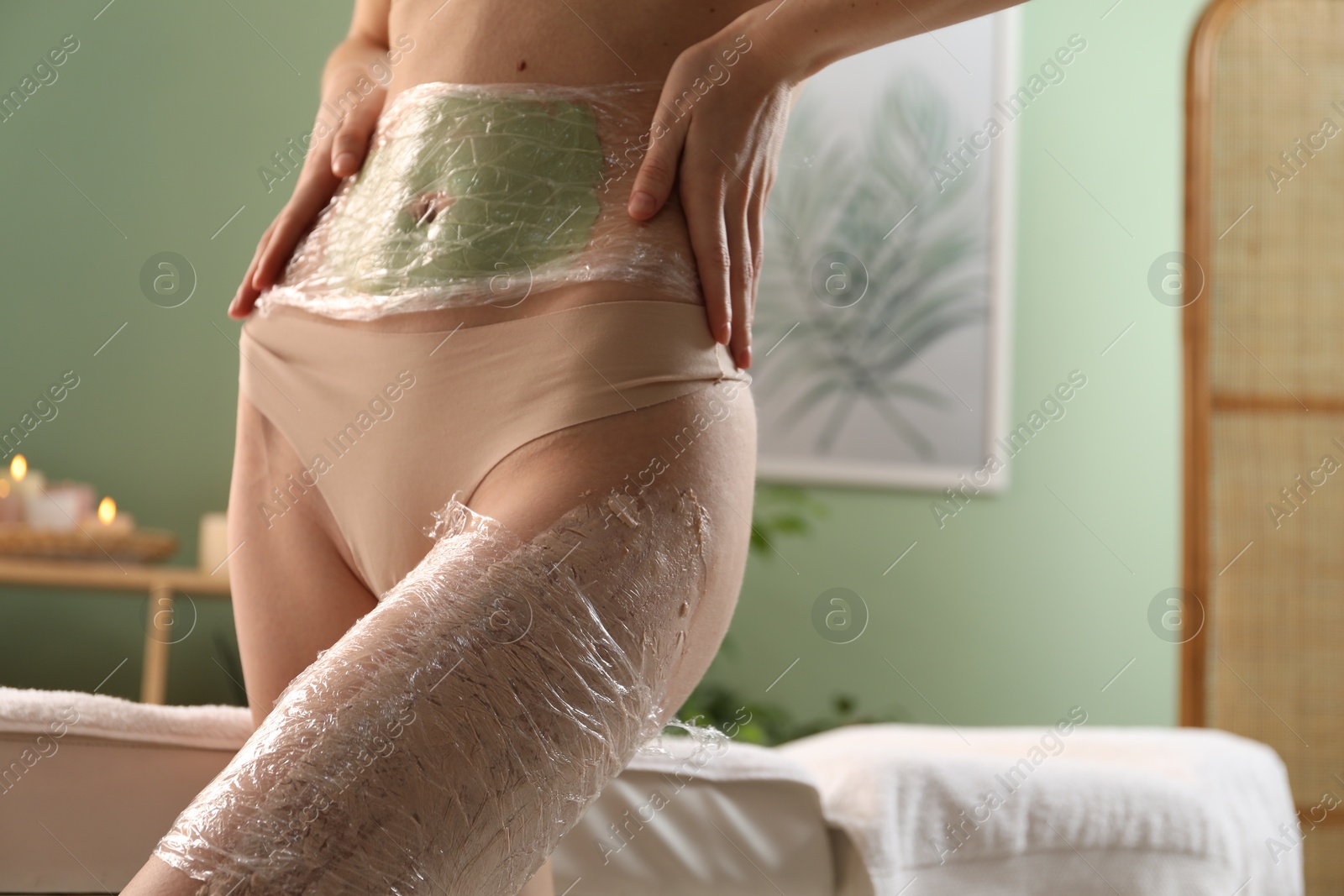 Photo of Woman doing spa body wraps on in salon, closeup. Space for text