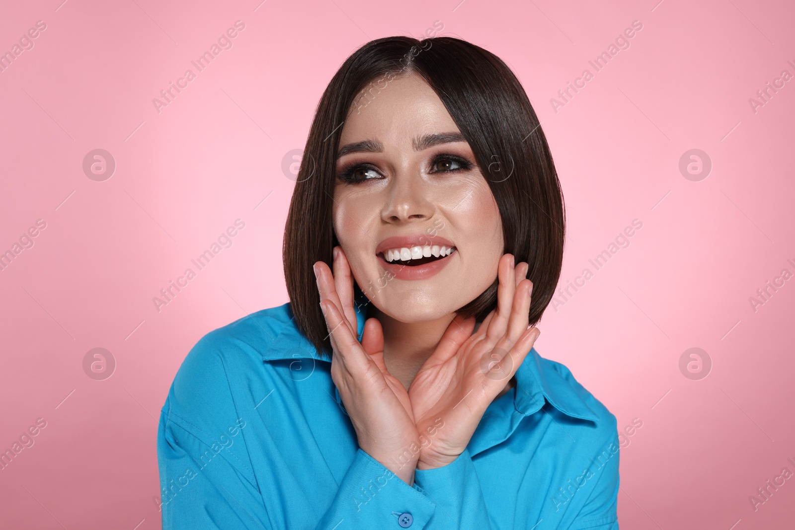 Photo of Portrait of beautiful young happy woman with gorgeous straight hair on pink background